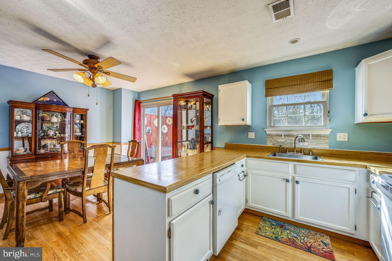 355 Rambling Ridge Court Pasadena, MD 21122 - Photo 5 of 28 a open kitchen with stainless steel appliances granite countertop a sink and dishwasher with a dining table