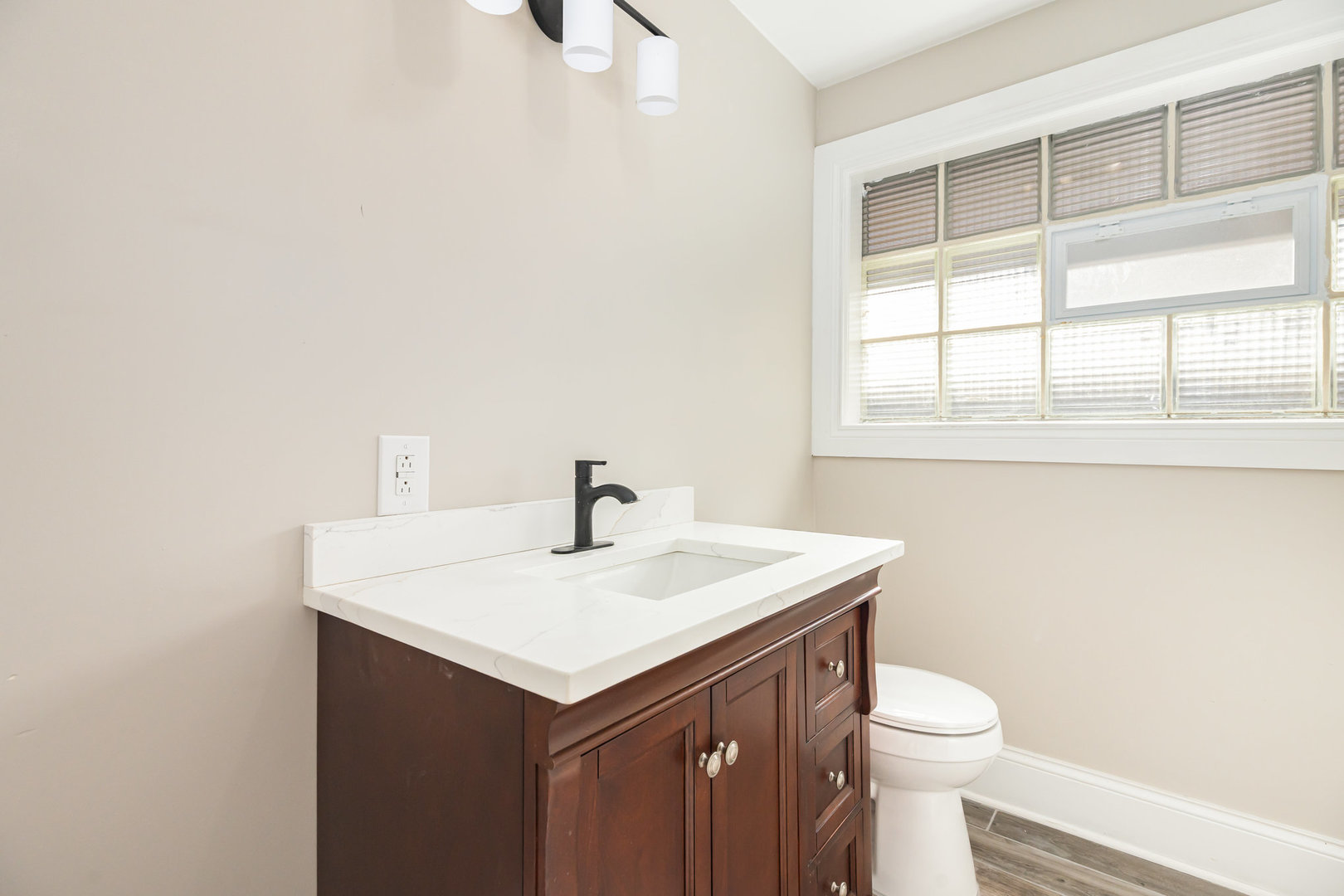 7332 South Honore Street Chicago, IL 60636 - Photo 13 of 27 a bathroom with a sink a toilet and a window