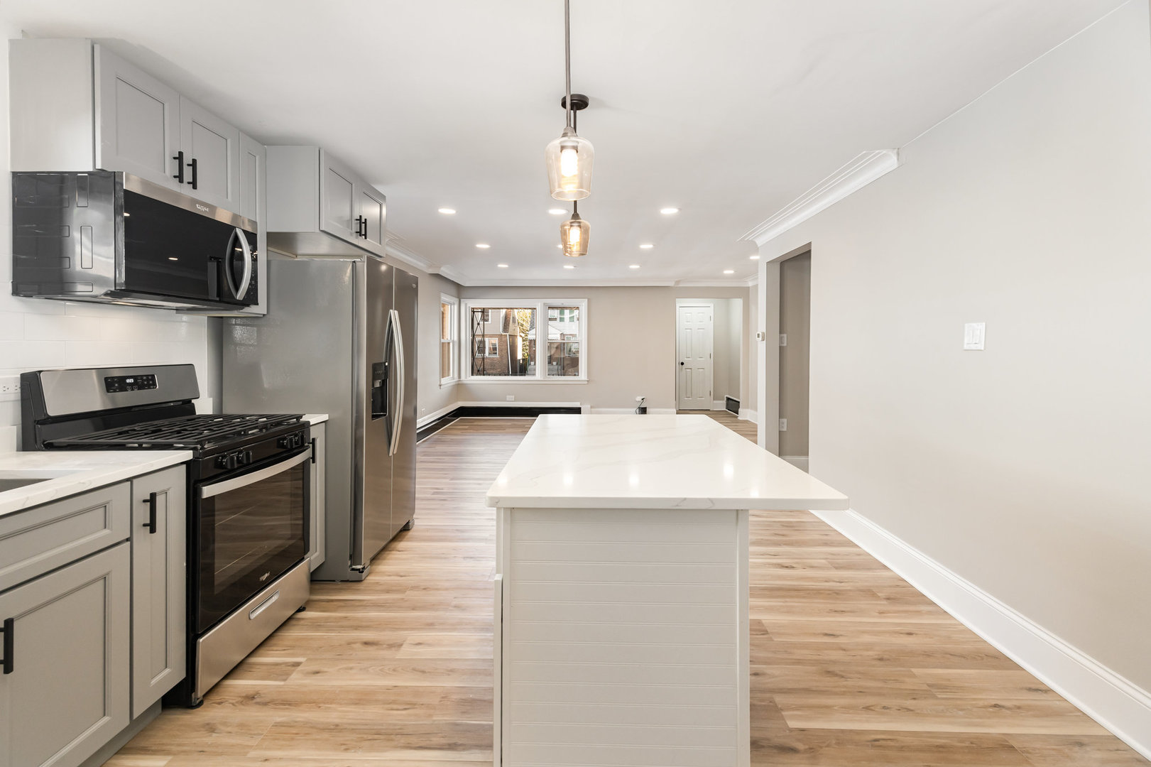 7332 South Honore Street Chicago, IL 60636 - Photo 7 of 27 a large kitchen with stainless steel appliances kitchen island granite countertop a stove and a sink