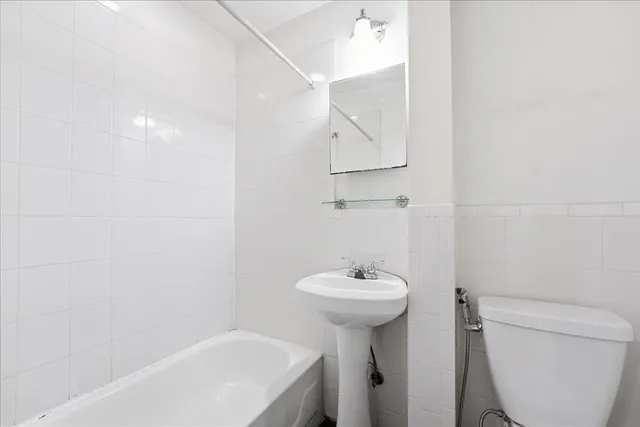 a bathroom with a sink a mirror and toilet