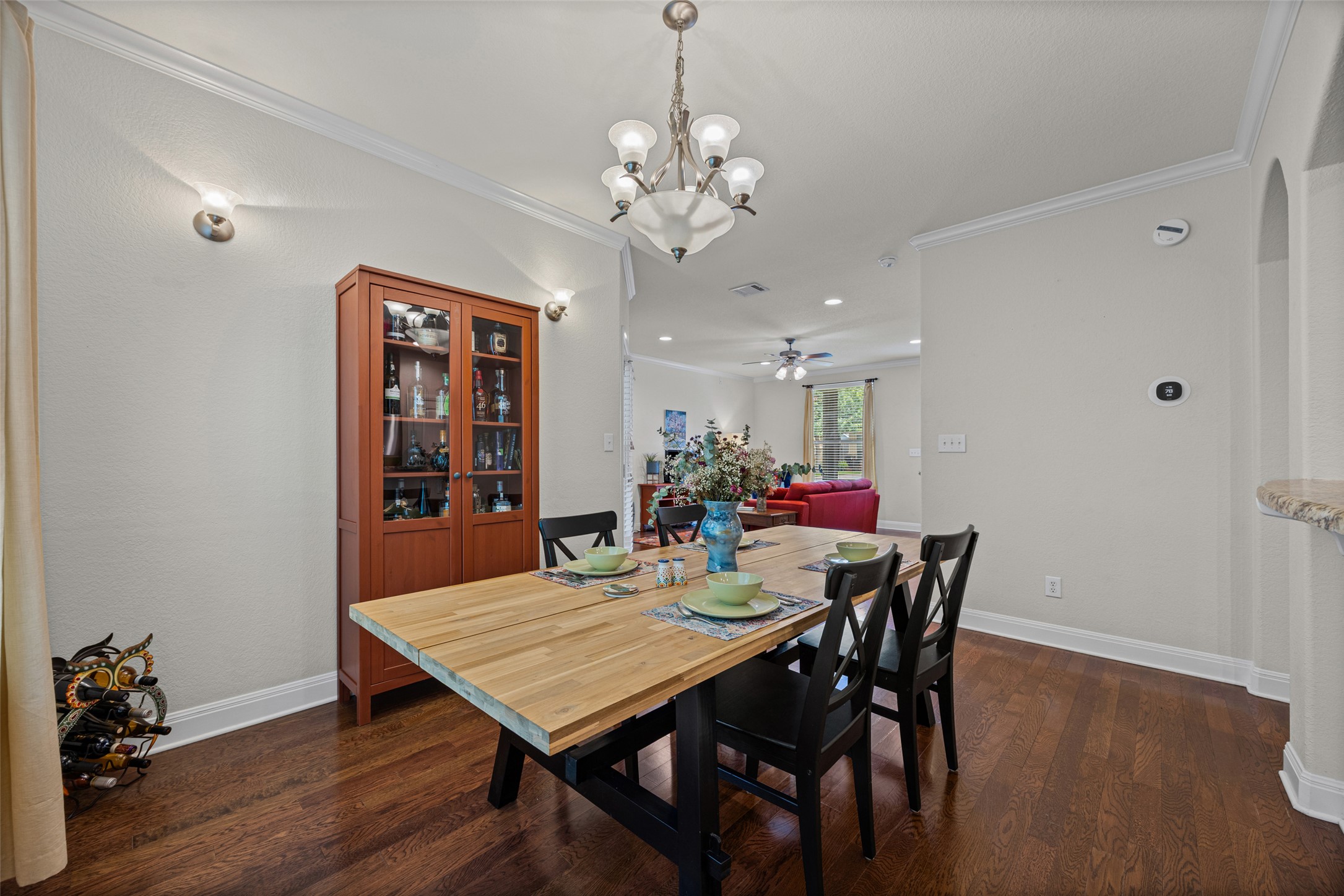 6708 Menchaca Road, Unit 10 Austin, TX 78745 - Photo 12 of 30 the dining area features dark hardwood flooring and elegant crown molding, leading into a spacious living room.