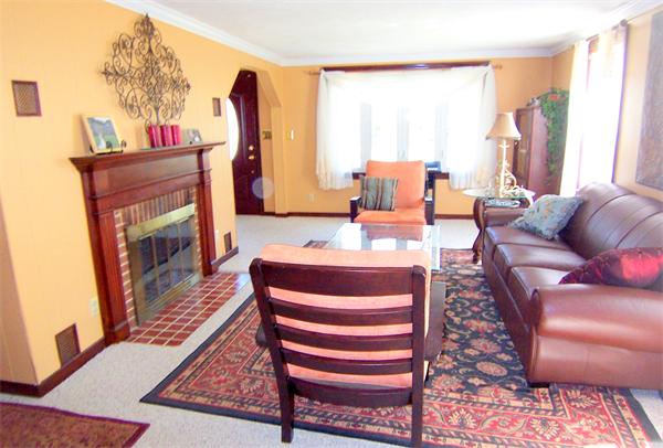 38 Granger Street Springfield, MA 01119 - Photo 15 of 30 a living room with furniture a fireplace and a large window
