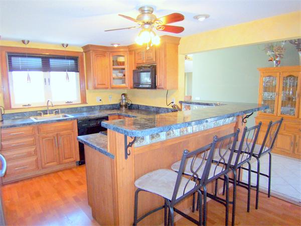 38 Granger Street Springfield, MA 01119 - Photo 5 of 30 a kitchen with a table chairs sink and cabinets