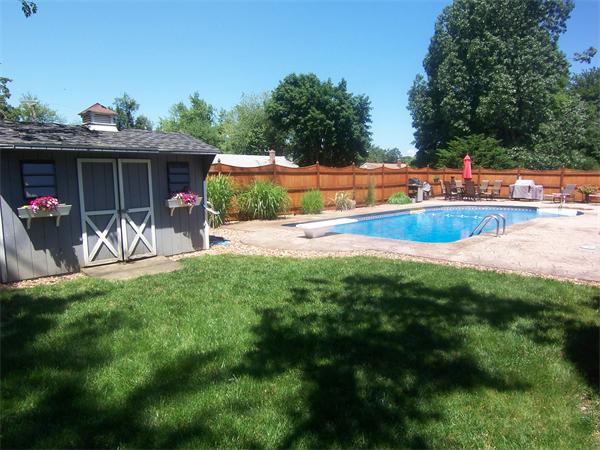 38 Granger Street Springfield, MA 01119 - Photo 8 of 30 a view of a swimming pool with a yard and potted plants
