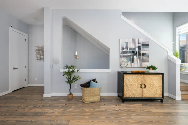 a living room with furniture and wooden floor