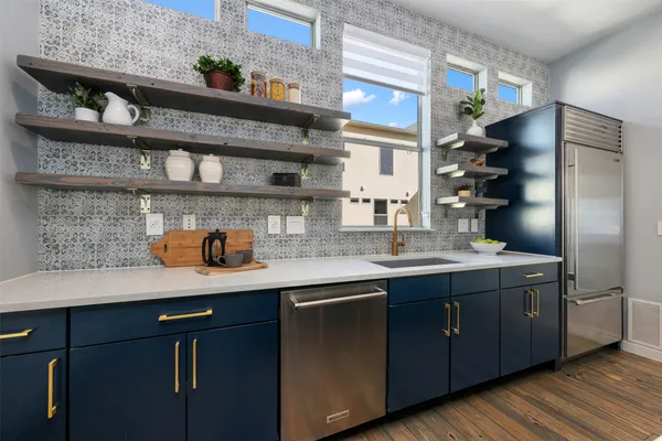 a kitchen with stainless steel appliances a sink and cabinets