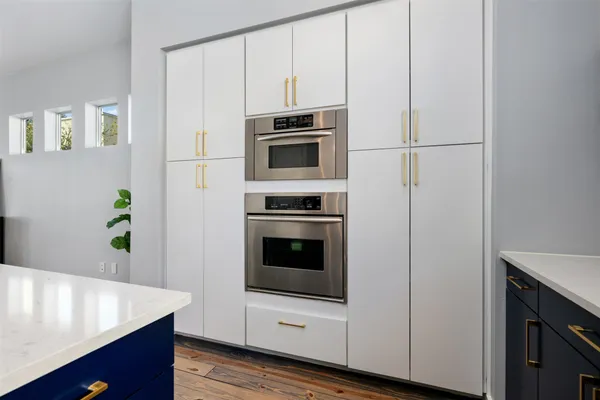 a kitchen with stainless steel appliances a stove microwave and refrigerator