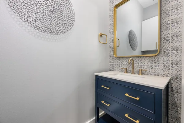 a bathroom with a sink a mirror and vanity