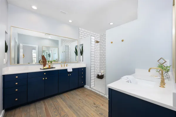 a spacious bathroom with a granite countertop sink mirror and vanity
