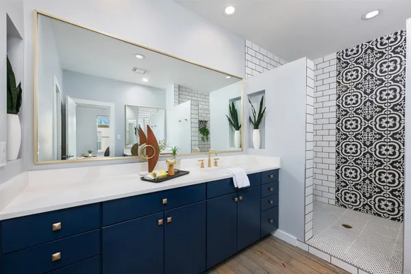 a spacious bathroom with a double vanity sink and a mirror