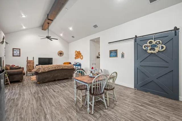 a bedroom with furniture and a wooden floor