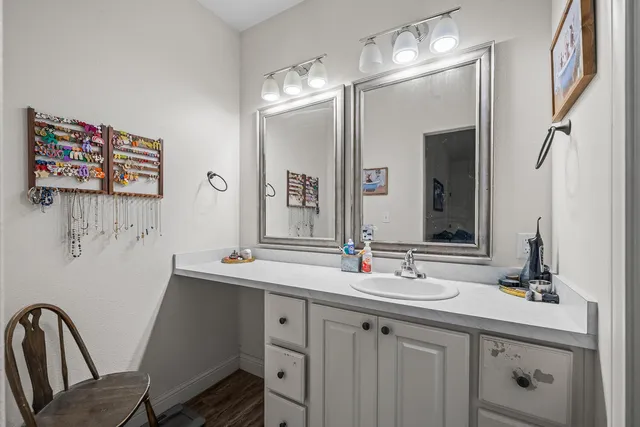a bathroom with a double vanity sink mirror and