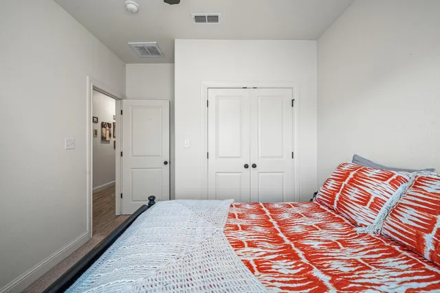 a bedroom with a bed and a rug