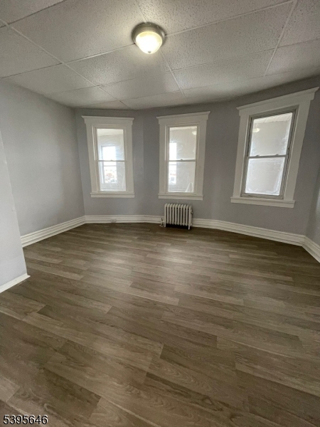 846 Market Street Paterson, NJ 07513 - Photo 4 of 11 an empty room with wooden floor and windows