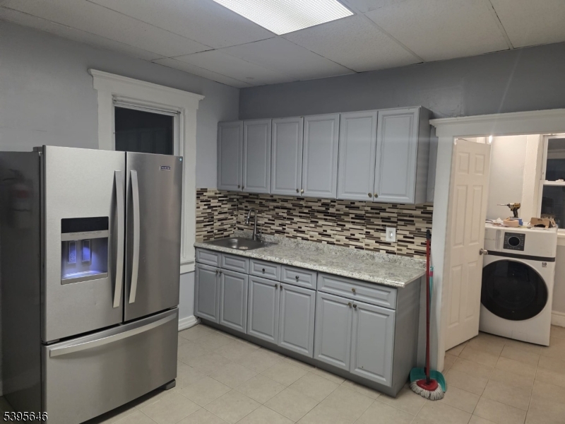 846 Market Street Paterson, NJ 07513 - Photo 9 of 11 a kitchen with stainless steel appliances granite countertop a refrigerator and a stove top oven