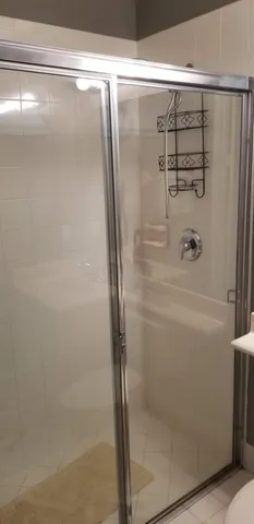 a bathroom with a glass shower door