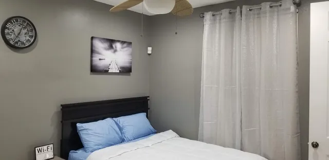 a bed sitting in a bedroom next to a window