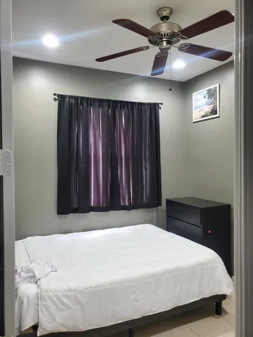 a bedroom with a bed and a table