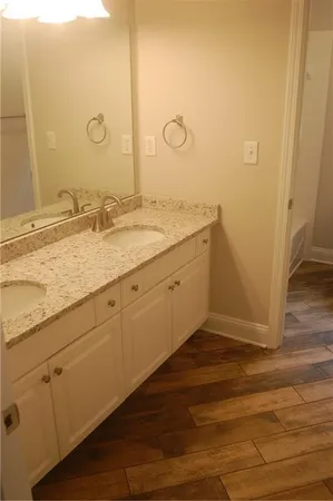 a bathroom with a granite countertop sink and a mirror
