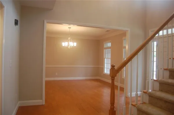 a view of entryway and hall with wooden floor
