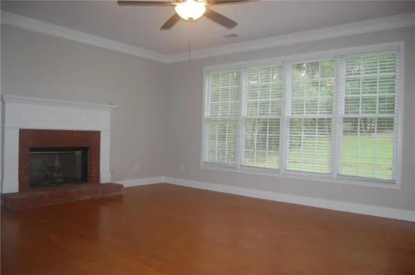 a view of empty room with window and fireplace