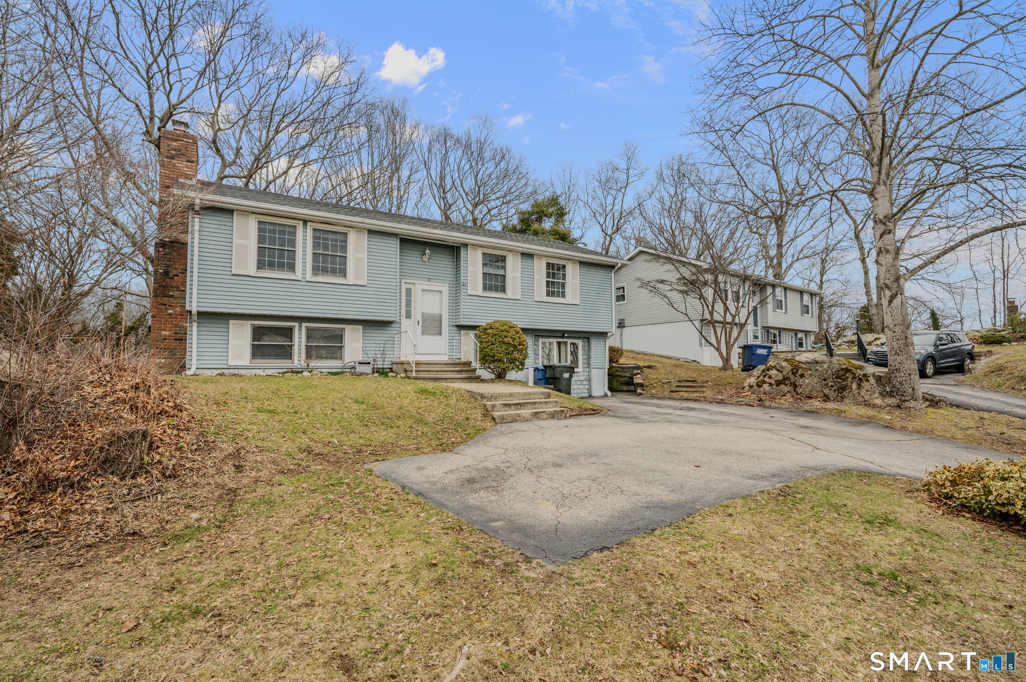 10 Amherst Court Groton, CT 06355 - Photo 2 of 25 a front view of a house with a yard covered in snow