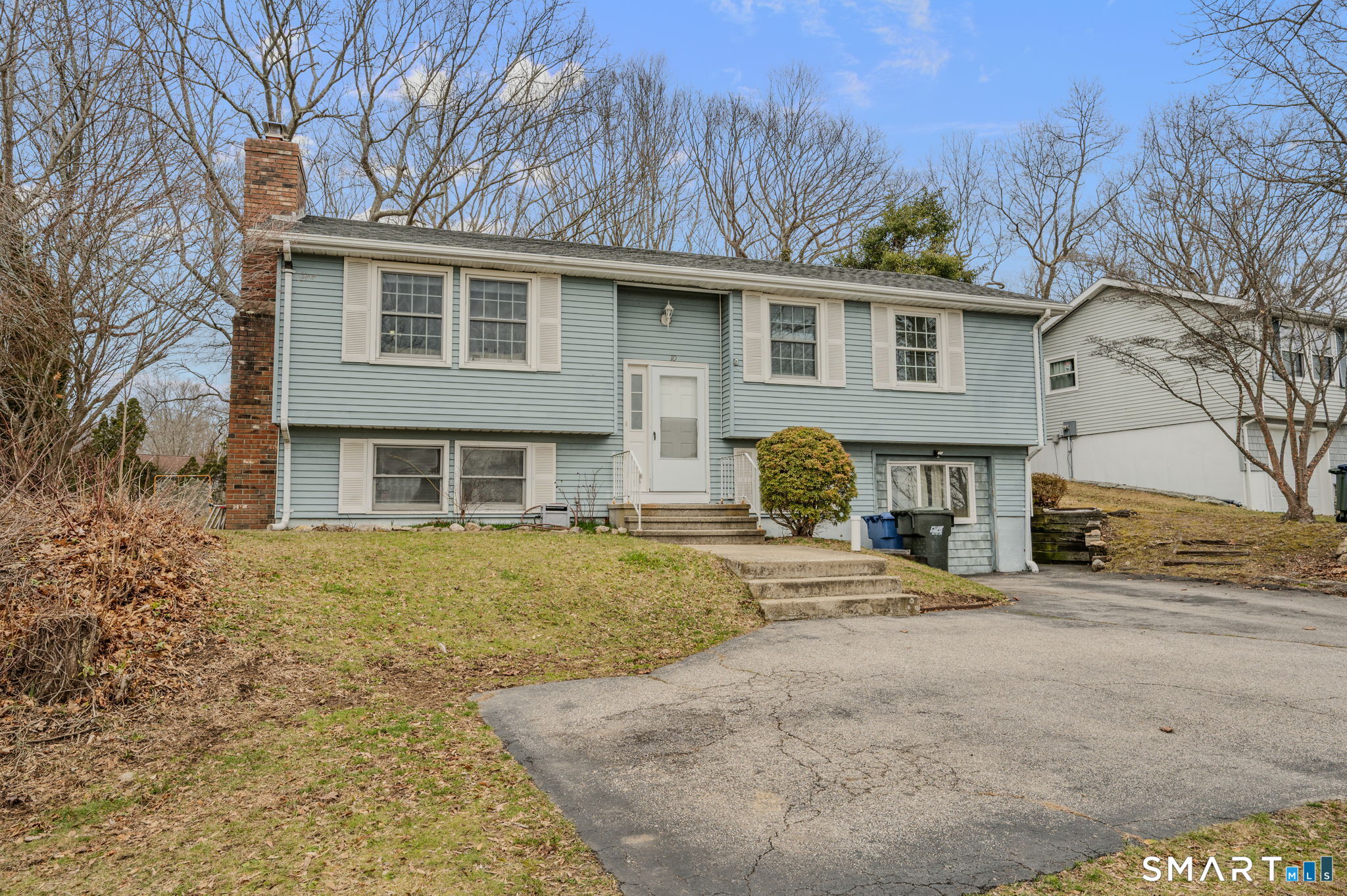 10 Amherst Court Groton, CT 06355 - Photo 3 of 25 a front view of a house with a yard and garage