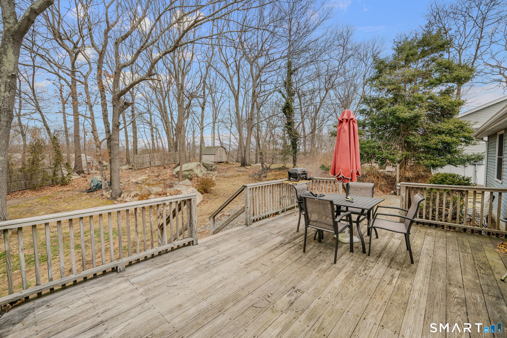 10 Amherst Court Groton, CT 06355 - Photo 6 of 25 a view of a roof deck with table and chairs and wooden floor