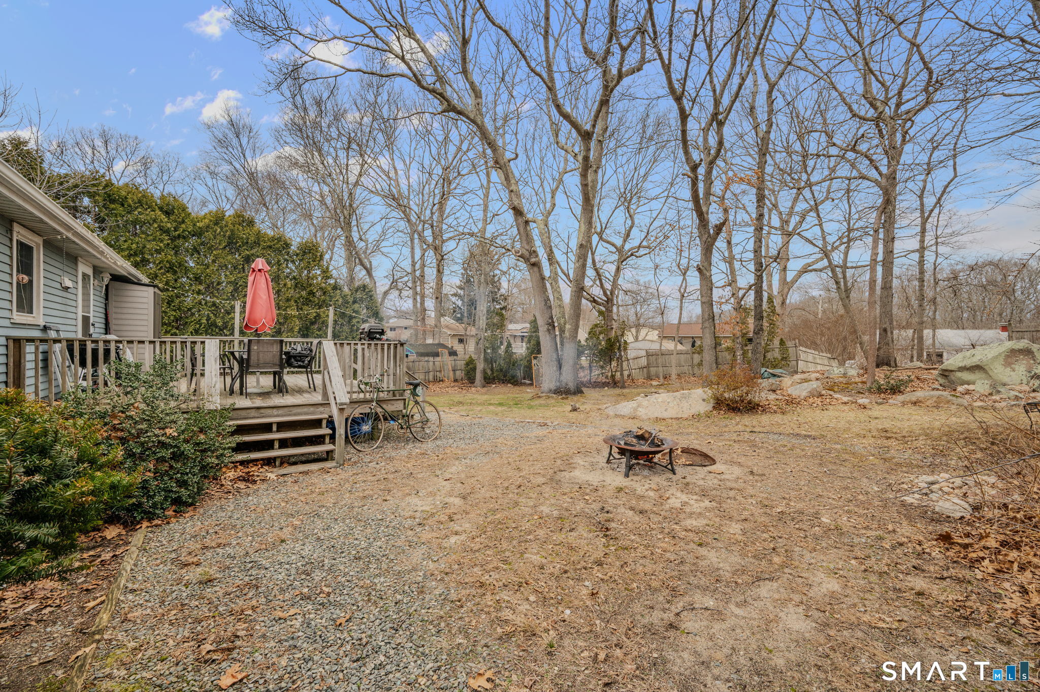 10 Amherst Court Groton, CT 06355 - Photo 7 of 25 a backyard of a house with fire pit and trees
