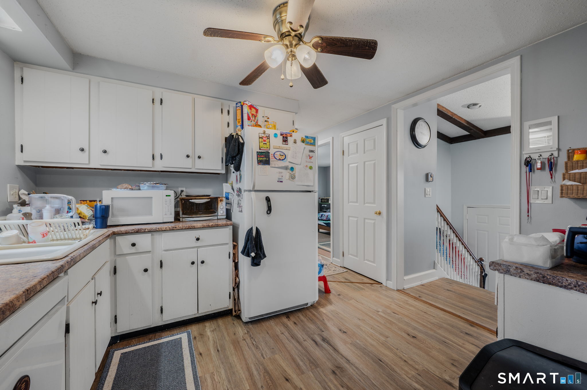 10 Amherst Court Groton, CT 06355 - Photo 9 of 25 a kitchen with cabinets a sink and wooden floor
