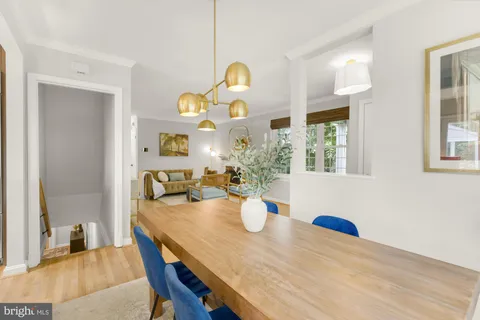 a view of a dining room with furniture and chandelier