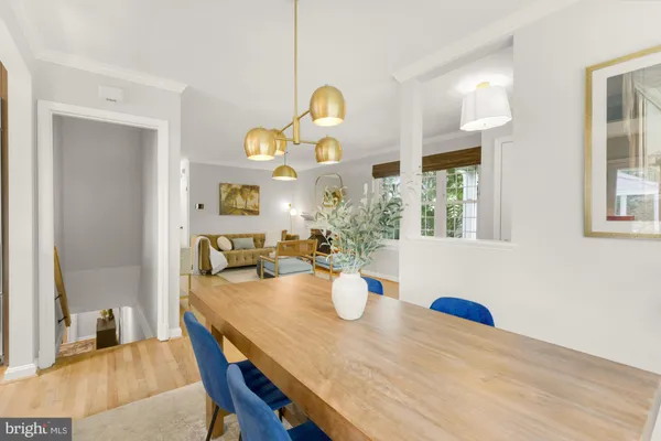 a view of a dining room with furniture and chandelier