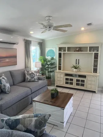 a living room with furniture and a chandelier
