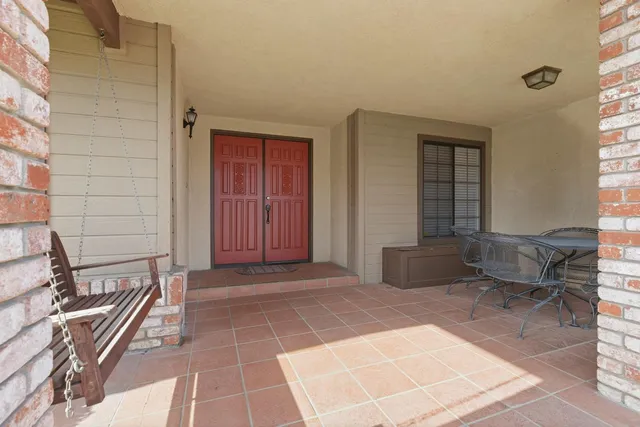 a view of a patio with a table and chairs