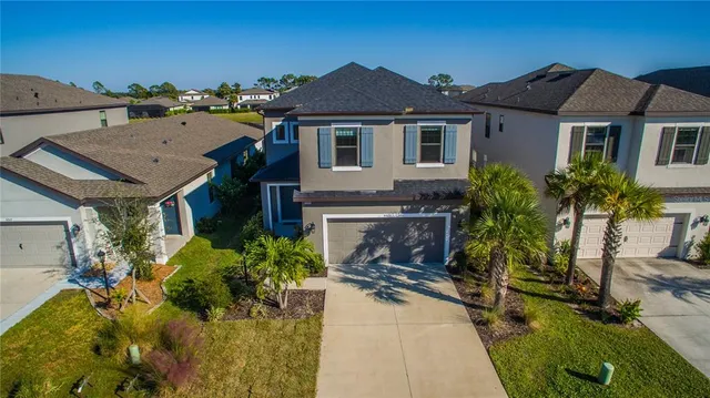 a aerial view of a house with a yard and potted plants