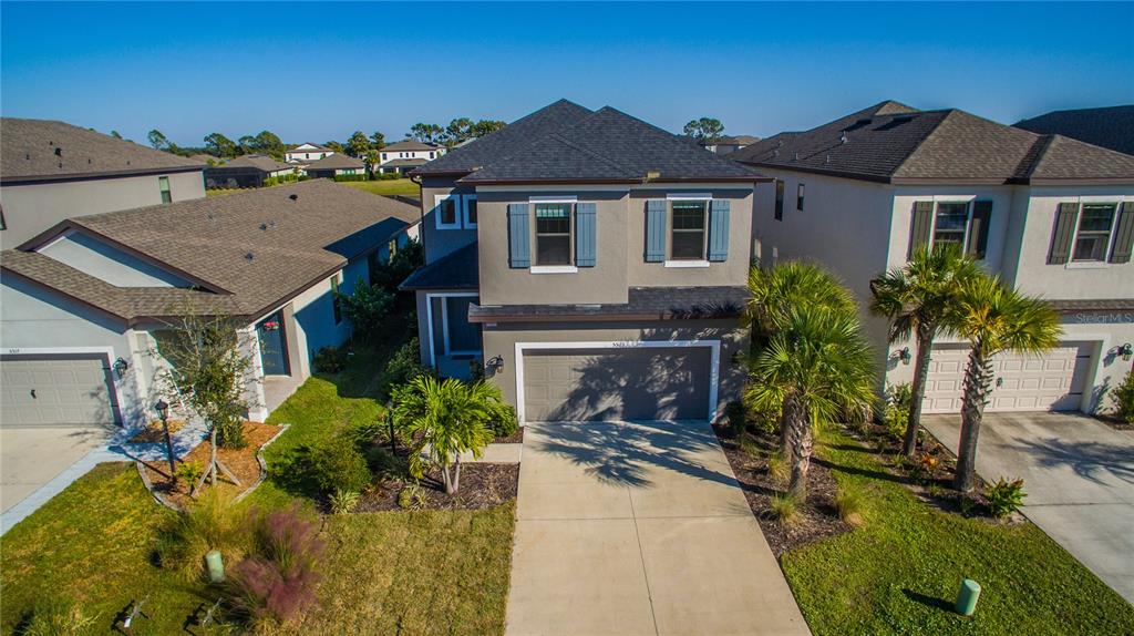 a aerial view of a house with a yard and potted plants