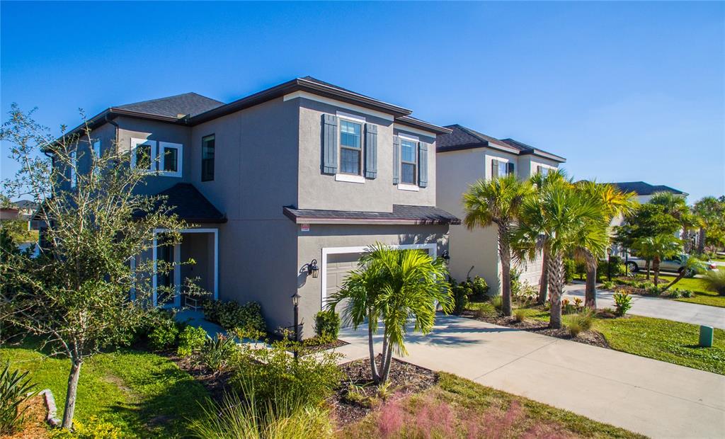 5521 Summit Glen Bradenton, FL 34203 - Photo 12 of 54 a front view of a house with a yard