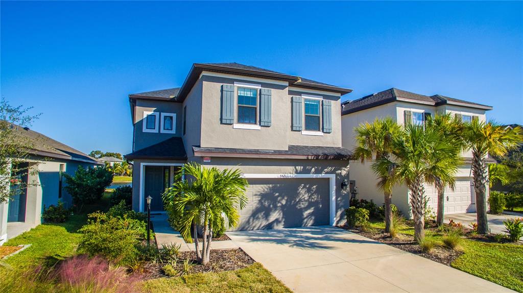 5521 Summit Glen Bradenton, FL 34203 - Photo 13 of 54 a front view of a house with a yard