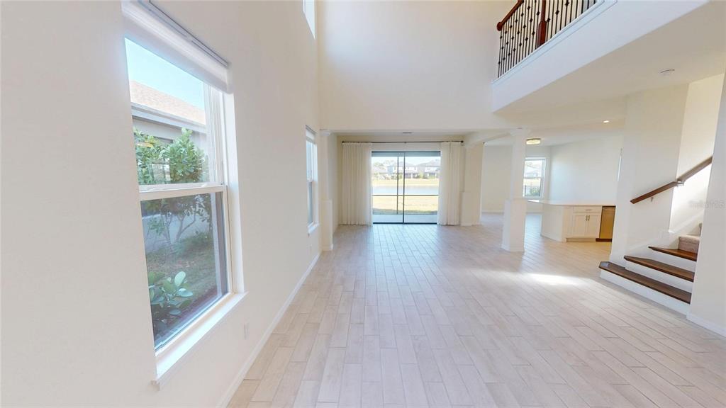 5521 Summit Glen Bradenton, FL 34203 - Photo 14 of 54 a view of a hallway with wooden floor and a living room