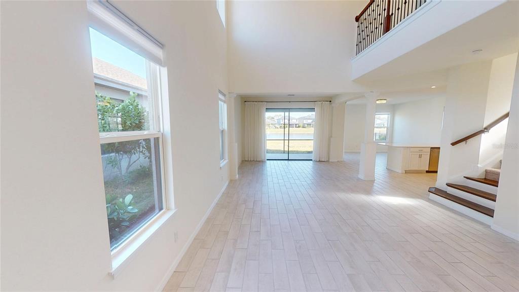 5521 Summit Glen Bradenton, FL 34203 - Photo 15 of 54 a view of a hallway with wooden floor and a living room