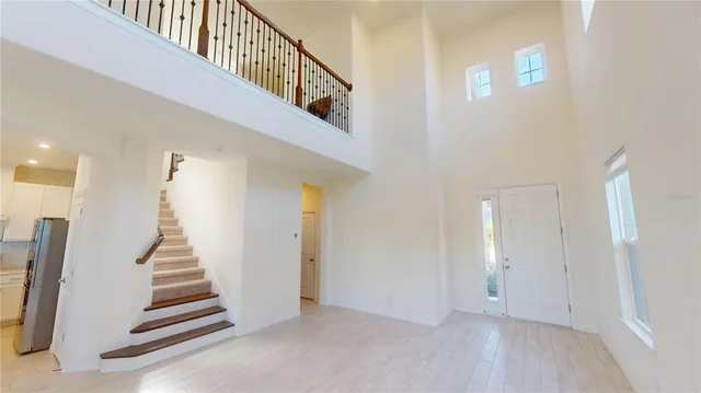 a view of a kitchen with refrigerator and a sink