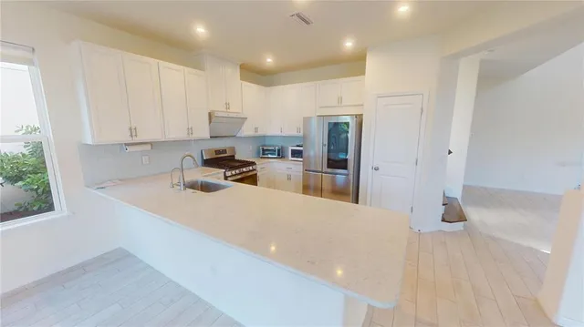 a view of kitchen with cabinets and wooden floor