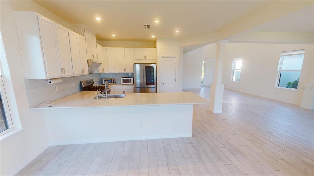 5521 Summit Glen Bradenton, FL 34203 - Photo 24 of 54 a view of kitchen with cabinets and wooden floor