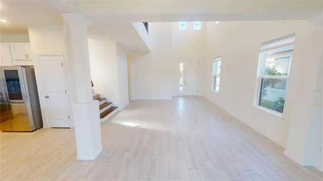 a view of a hallway with entryway and a window