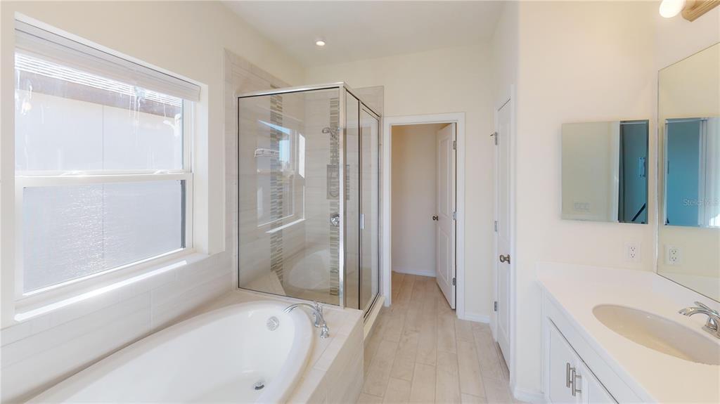 5521 Summit Glen Bradenton, FL 34203 - Photo 37 of 54 a bathroom with a tub shower sink and mirror