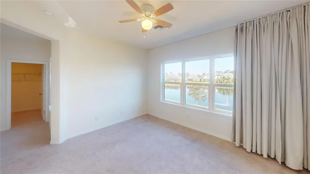 a white vase with flowers sitting on a table
