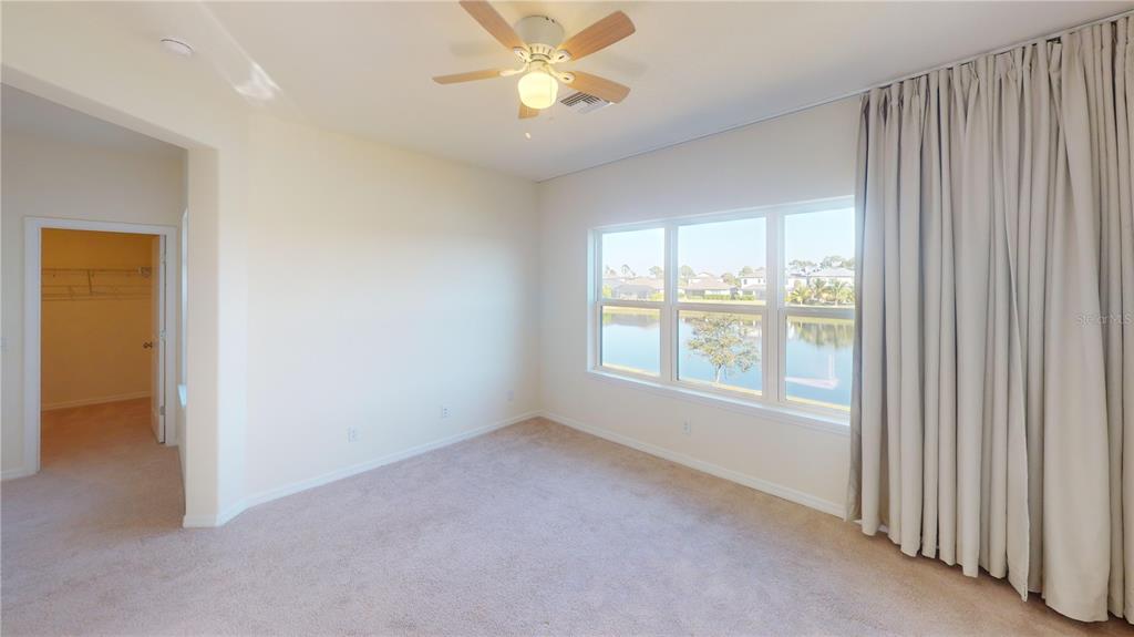 5521 Summit Glen Bradenton, FL 34203 - Photo 38 of 54 an empty room with windows and fan