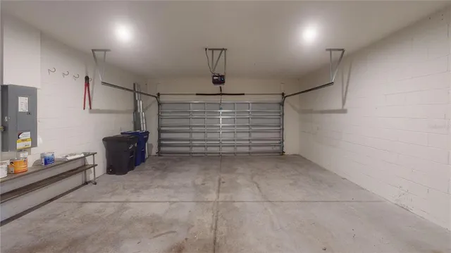 a view of kitchen with kitchen island a sink wooden floor and white stainless steel appliances