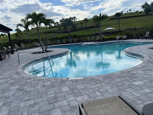 a view of a swimming pool with a patio