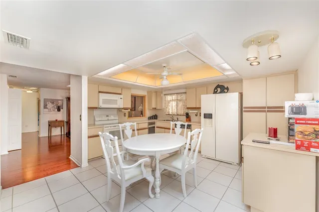 a dining room with furniture and a chandelier